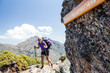 Woman hiking with backpack in mountains