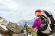 Woman hiking with backpack in mountains, France