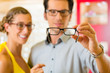 Young couple at optician with glasses