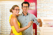 Young couple at optician with glasses