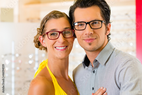 Photo: Young couple at optician with glasses Young couple at optician with glasses