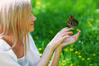 Woman playing with a butterfly