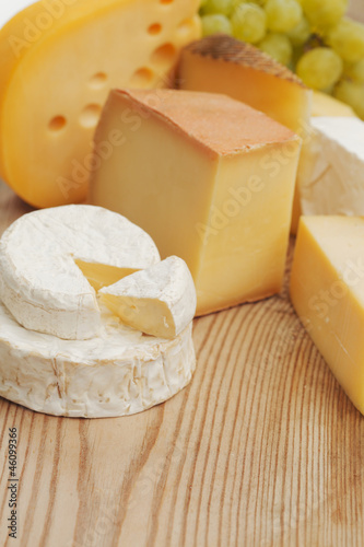 Photo: cheese on a wooden table cheese on a wooden table