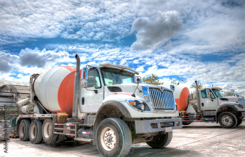 Photo: Mixer truck with a beautiful cloudscape in the background Mixer truck with a beautiful cloudscape in the background