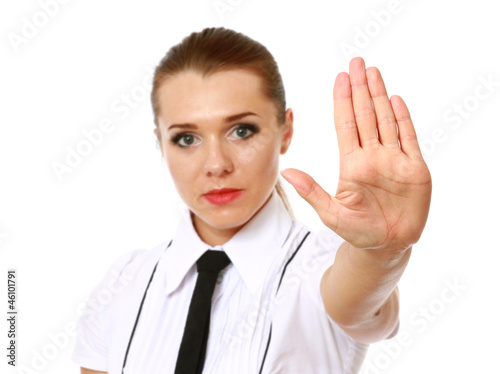Photo: Woman smiling and showing his hand in signal of stop Woman smiling and showing his hand in signal of stop