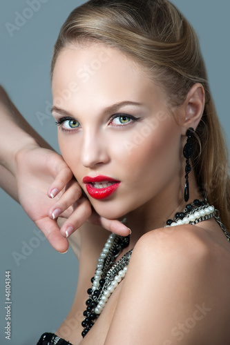 Photo: Young woman model with glamour red lips,bright makeup, eye arrow Young woman model with glamour red lips,bright makeup, eye arrow