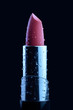 Wet lipstick against black background