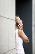 attractive woman speaking on telephone near office building