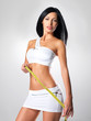 Sporty beautiful woman with measure tape