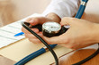 A doctor is measuring blood pressure with a tonometer