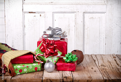 Photo: Christmas presents spilling out of a stocking Christmas presents spilling out of a stocking