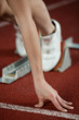 Detailed view of a female sprinter ready to go
