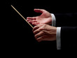 Hands of a conductor on black background
