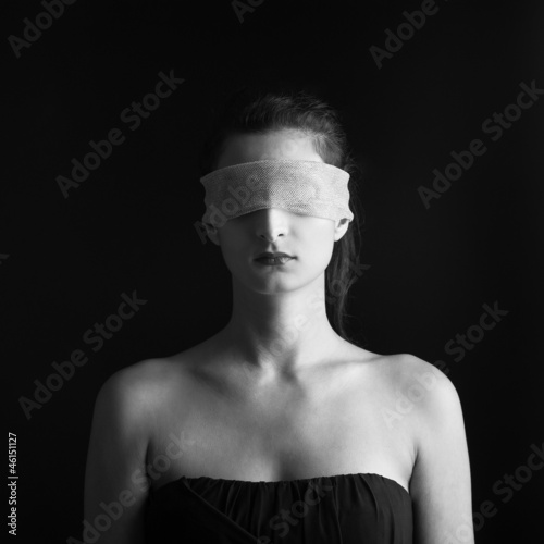 Photo: Close up of woman constrained by gauze ring on eyes. Close up of woman constrained by gauze ring on eyes.