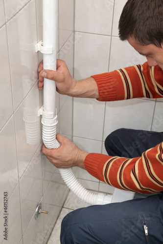 Photo: Plumber fix plastic tube, of wall mounted toilet cistern Plumber fix plastic tube, of wall mounted toilet cistern