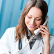 Foto: Young doctor on phone, at office Young doctor on phone, at office