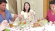 Group Of Friends Eating Meal Together In Dining Room