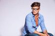 fashion model sitting and looking to his right side