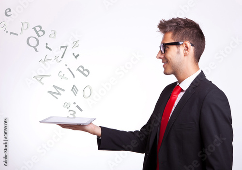 Photo: young business man holding a touch screen pad young business man holding a touch screen pad