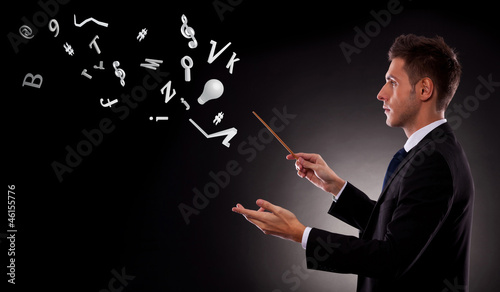 Photo: business man directing lots of symbols business man directing lots of symbols
