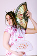 Geisha. Woman wearing traditional dress holding the fans