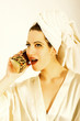 Woman holding her shoe like phone