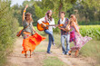 Hippie Group Playing Music and Dancing Outside