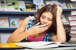 Beautiful female student in a library