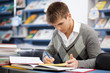 Handsome male student in a library