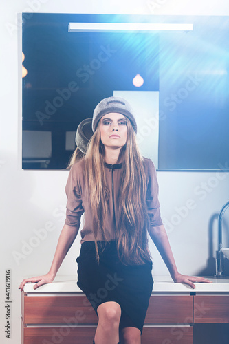 Photo: Glamour woman sits on washstand Glamour woman sits on washstand