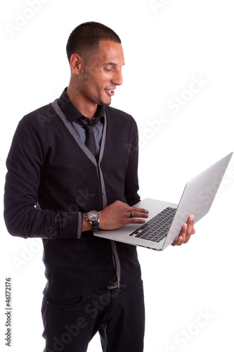 Photo: Young african american man using a laptop Young african american man using a laptop