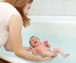 Foto: mother wasing newborn baby mother wasing newborn baby