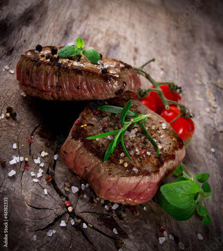 Photo: Grilled bbq steaks with fresh herbs and tomatoes Grilled bbq steaks with fresh herbs and tomatoes