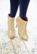 Frauenbeine mit Glitzerboots