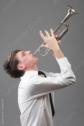 Photo: Portrait of a young man playing his Trumpet Portrait of a young man playing his Trumpet