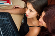 Hispanic girl and her mother working on a computer at home