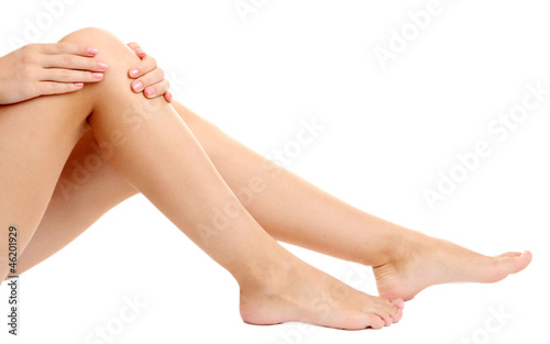 Photo: woman holding sore knee, isolated on white woman holding sore knee, isolated on white