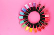 Photo: Group of bright nail polishes, on pink background Group of bright nail polishes, on pink background