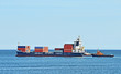Tugboat assisting cargo ship over lighthouse in Odessa, Ukraine