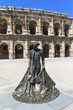 Nimeño II statue and Roman Amphitheater in Nimes, France
