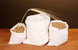 Flour and wheat grain on wooden table on dark background