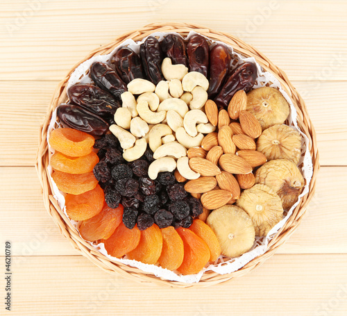 Photo: different dried fruits on wooden background different dried fruits on wooden background