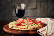 Pizza with cherry tomatoes and basil on wooden board