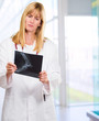 serious doctor looking at an x-ray