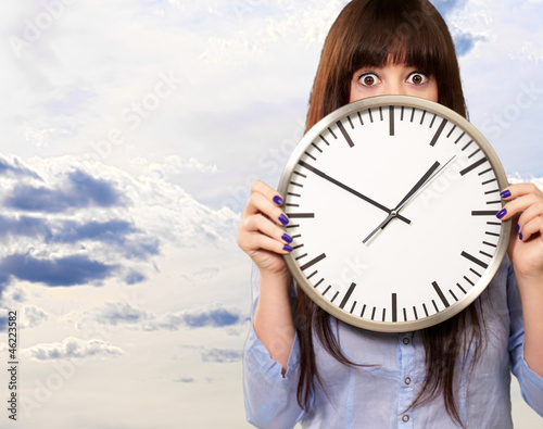 Photo: Woman Holding Clock Woman Holding Clock