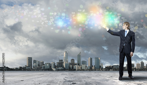 Photo: Businessman with colourful light beam in his hands Businessman with colourful light beam in his hands