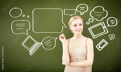 Photo: portrait of young teacher near blackboard portrait of young teacher near blackboard