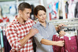 Young family at clothes shopping store