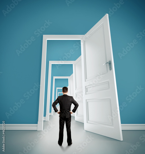 Photo: businessman in blue room with doors open businessman in blue room with doors open