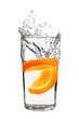 Photo: orange splashing into glass of water on white background orange splashing into glass of water on white background